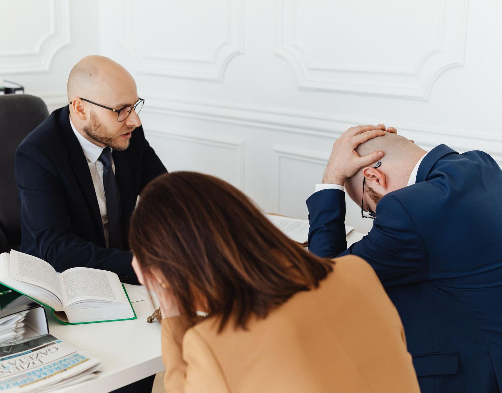 A Lawyer Talking to His Clients